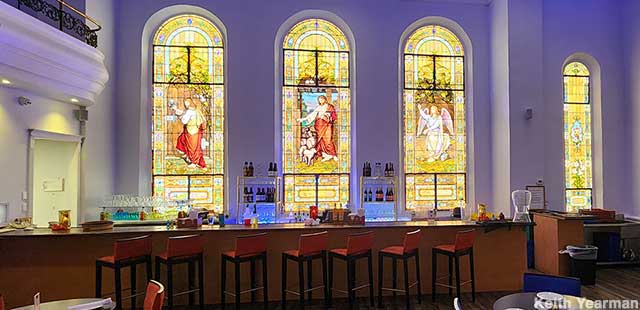 Stained glass windows behind the bar.