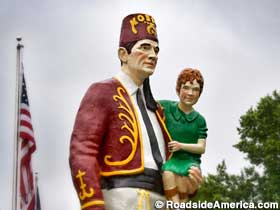 Shriner carries a child.