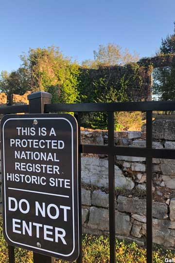 National Register Historic Site sign and fence.