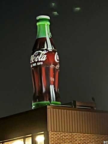 Coke bottle at night.