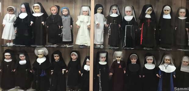 Nun doll collection behind glass.