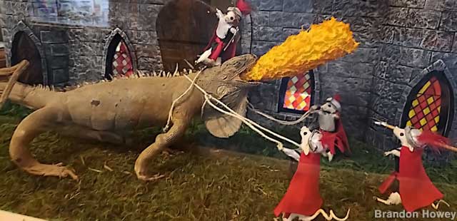 Valiant mouse knights fight a fire-breathing iguana.