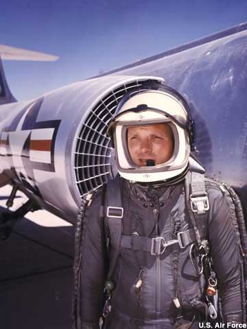 In a high-altitude partial pressure suit, Capt. Iven C. Kincheloe Jr. and an F-104.