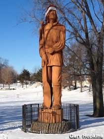 Voyageur statue with Santa cap.