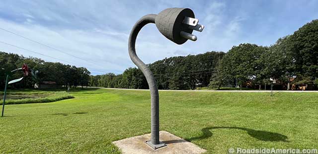 Three-prong plug stands 12 feet high, took 184 hours to build. Ken keeps track of all his sculpture stats.