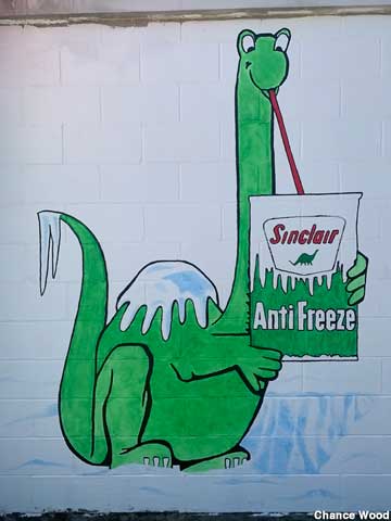 Sinclair dinosaur drinking antifreeze.