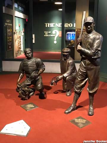 Bronze statues of Hall of Famers at home base.