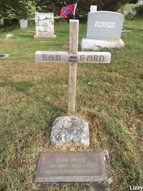 Wooden cross and grave of Bob Ford.