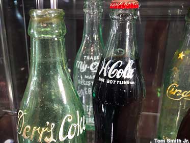Bottled soda over 100 years old is unsafe to drink.