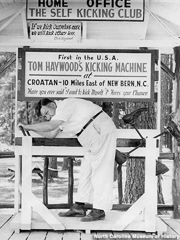 Tom Haywood demonstrates his Kicking Machine in 1953.