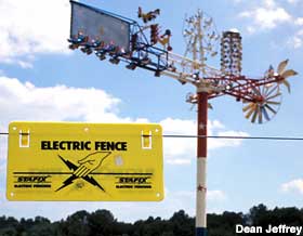 Electric fence guards the whirlygig.
