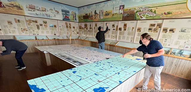 Museum director Shane Engeland points to another tiny North Dakota town on the regional history map.