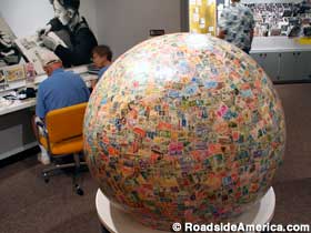 Stamp enthusiasts browse in the aura of the World's Largest Ball of Stamps.