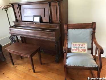 Piano and reserved chair.