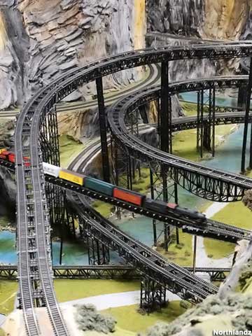 Railways cross and converge over model rivers.