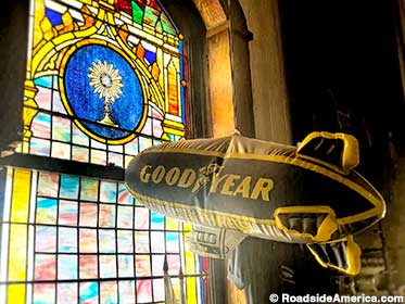Goodyear blimp and stained glass window.