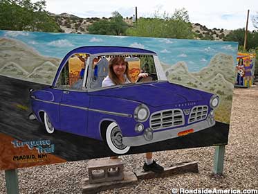 Connie drives a cutout car on the Turquoise Trail.