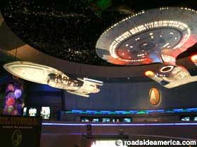 Replica starships hover over the entrance to Star Trek: The Experience.