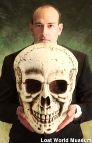 John Adolfi and replica skull of pre-human giant.