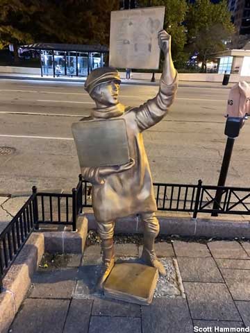Newsboy statue.