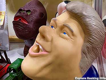 Bill Clinton and ape invite you to stick something in their mouths.
