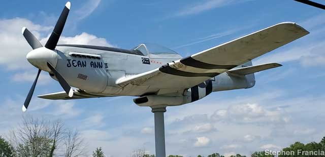 Mustang fighter plane on a pole.