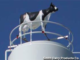 Cow atop a dairy silo.