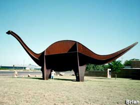 Metal dinosaur sculpture.