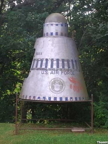Gas Station Space Capsule is elevated on a metal frame.