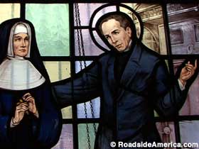 Stained glass scene of John Neumann with a nun.