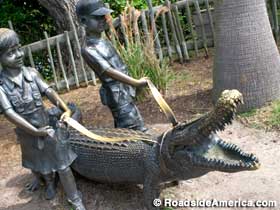 Bronze statue of gator and kids.