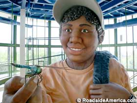 Giant kid holds a dragonfly.
