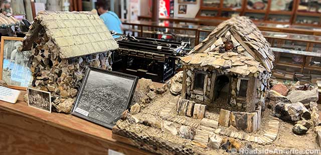 Miniature replicas of petrified wood houses. Smallest photo is of petrified wood tombstones.