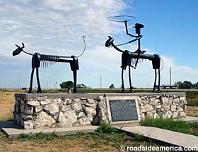 Metal rancher sculpture.