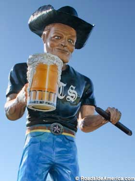 Muffler Man with beer and a cigar.