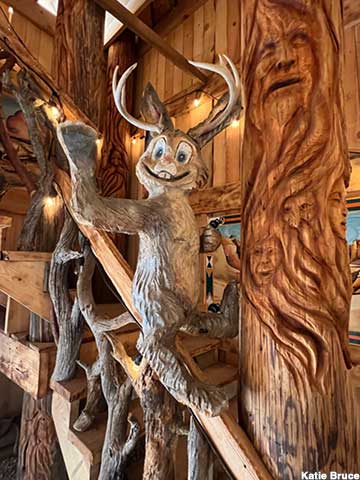 Jackalope and wood spirits flank the indoor staircase.