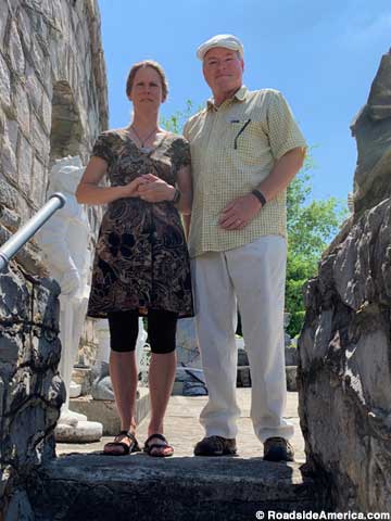 Two middle-aged people, Karen and Dean Fontaine, stand at the top of an outdoor staircase.