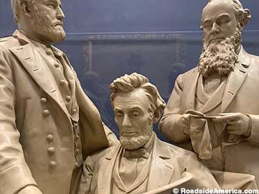Abe studies a war map with plaster Grant and Stanton.