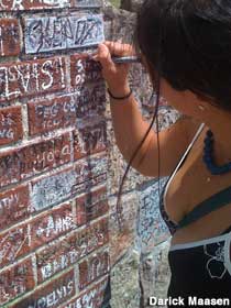 Signing the wall at Graceland.