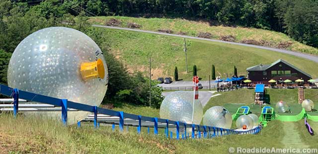 One-of-a-kind escalator hauls orbs up the hill to waiting Gravity Park passengers.