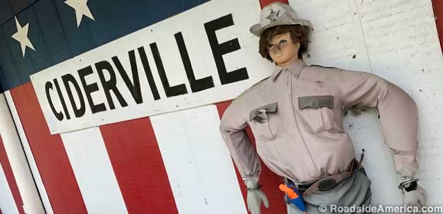 Deputy dummy guards the red, white, and blue exterior of Ciderville.