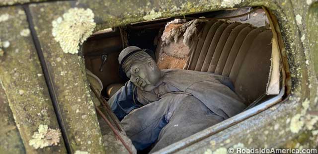 Shadowy passenger inside one of Ciderville's encrusted cars.