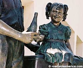 Bronze girl grabs for Dr Pepper outside the bottling plant in Dublin, Texas.
