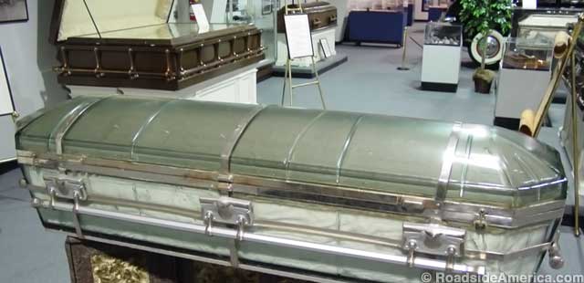 The glass coffin. In the background, a casket for three.