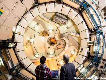 Visitors peer into the dizzying full-size Skylab mockup.