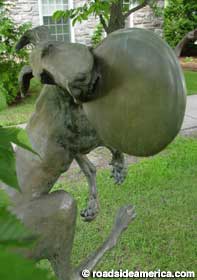 Statue of dog catching a frisbee.