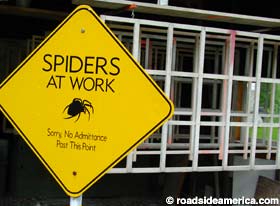 Sign reads: Spiders at Work.