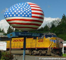 Freight train rumbles by the World's Largest Egg, 2004.