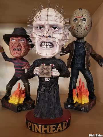 Bobbleheads of movie killers Jason, Pinhead, and Freddy Krueger.