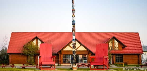 Two giant chairs and a totem pole.
